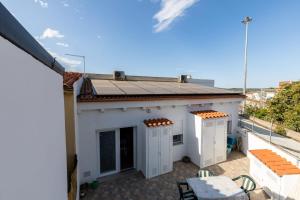 a white house with a solar roof on a balcony at GaLi eco-apartment in Olbia