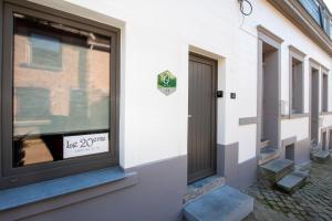 a front door of a building with a sign in a window at gîte le vingtieme in Spa +4 photos