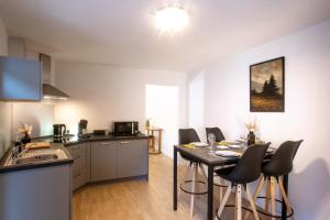 a kitchen and dining room with a table and chairs at gîte le vingtieme in Spa