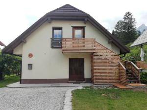 a small house with a balcony and a door at Apartma Tima in Bovec