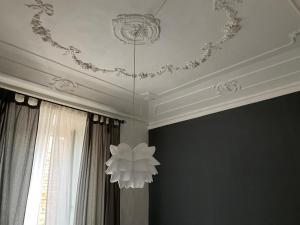 a ceiling with a chandelier in a room at AUXIMUM Appartamenti in Osimo