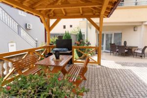 a patio with a wooden pergola and a table at Apartments Sejla in Ulcinj