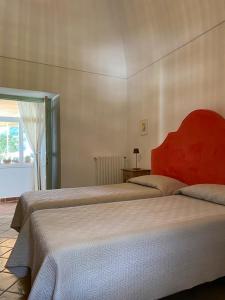 a bedroom with two beds and a window at Casa Positamo in Positano