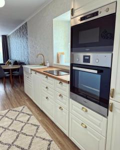 a kitchen with a sink and a stove top oven at Lakeside Home in Siófok