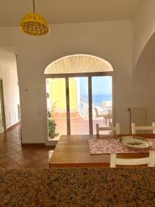 a dining room with a table and a view of the ocean at Casa Positamo in Positano