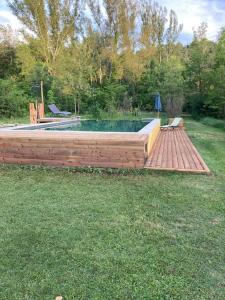 a wooden deck with a pool in a yard at Mas Paradiso in Allemagne-en-Provence