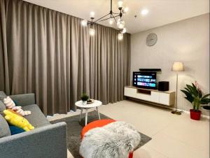 a living room with a couch and a tv at Arcoris Mont Kiara 1 to 5 pax Designer Netflix Chill Balcony in Kuala Lumpur