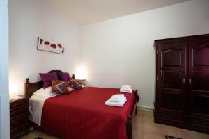 מיטה או מיטות בחדר ב-Conforto Citadino