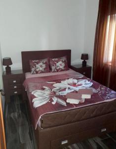 a bedroom with a bed with flowers on it at Apartman Jovicevic Pavle in Rijeka Crnojevića