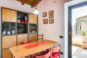 a dining room with a wooden table and chairs at Nearby 5Terre Authentic Apartment in Carrodano Inferiore