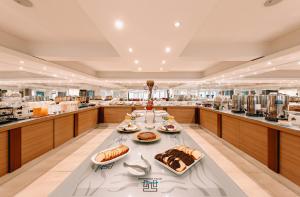 a large kitchen with a table with food on it at Hotel Tronador in Mar del Plata