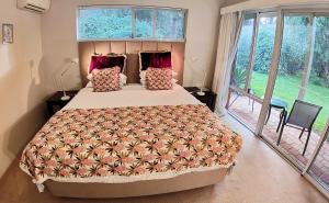 a bedroom with a bed and a large window at Margaret River Bed & Breakfast in Margaret River Town