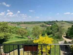 a view of the countryside from the balcony of a house at La Casa Celeste B&B in Asti