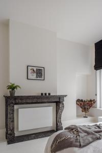 a fireplace in a living room with white walls at LuxuryApartmentSoulforCity in Ghent +33 photos