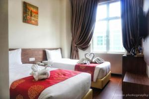 Postel nebo postele na pokoji v ubytování Nex Hotel Johor Bahru