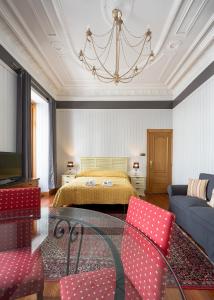 a bedroom with a bed and a table and chairs at Ayala apartment by People Rentals in Bilbao