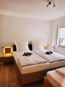 a bedroom with a bed with two hats on it at Exklusivwohnung Nempitz in Nempitz