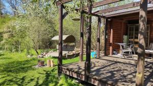 una veranda di una cabina con tavolo e sedia di Große Wohnung / Haushälfte in Peetzig am See ad Angermünde