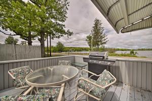 a patio with a table and chairs and a grill at Pet-Friendly Togus Pond Home Kayak and Canoe! in Augusta
