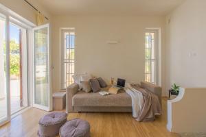a living room with a couch with a laptop on it at Villa Agave al mare in Specchiolla 