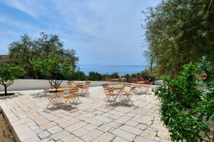 a patio with a bunch of chairs and tables at White Hotel in Borsh