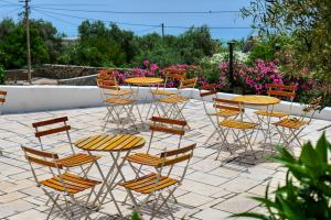 a group of chairs and tables and tables and chairs at White Hotel in Borsh
