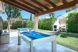 a pool table on a patio with awning at Owl Booking Villa Llenaire Gran - 3 min Walk to the Beach in Port de Pollensa