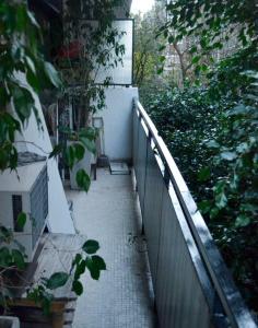 a walkway leading up to a building with a fence at San Benito 1538 by depptö in Buenos Aires