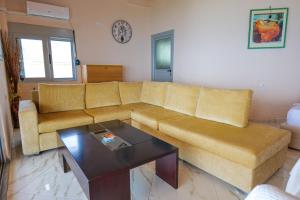 a living room with a couch and a coffee table at White Hotel in Borsh
