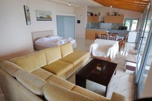 a living room with a couch and a table at White Hotel in Borsh