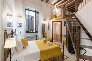 a bedroom with a bed and a spiral staircase at Cagliarifornia in Cagliari