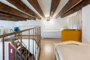 a room with two beds and a staircase in it at Cagliarifornia in Cagliari