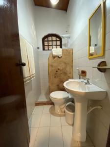 a bathroom with a sink and a toilet at Hospedagem do Sítio in Lençóis