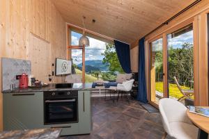 a kitchen and living room with a view of the mountains at Balthasar Volcano Apartments - Adults only in St. Wolfgang