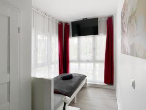 Televízia a/alebo spoločenská miestnosť v ubytovaní Schwanenburg Apartments