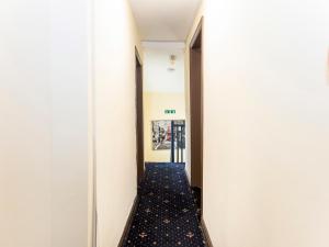 a hallway in a building with a long corridor at Old Oak Tree Inn in Hounslow