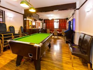 a billiard room with a pool table and chairs at Old Oak Tree Inn in Hounslow