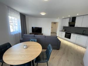 a kitchen and a living room with a table and a couch at Sofia Apartments in Baden-Baden