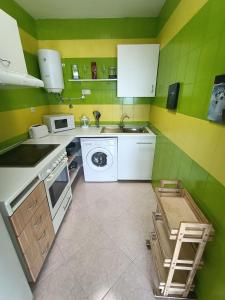 a kitchen with a sink and a washing machine at Jandia Beach in Morro del Jable