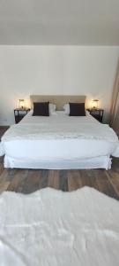 - une chambre avec un grand lit blanc et 2 oreillers dans l'établissement Brown, à Penmarcʼh