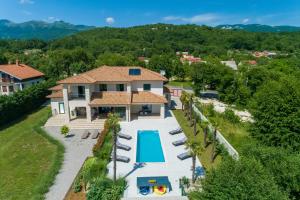 an aerial view of a villa with a swimming pool at Villa Palma with Heated Private Pool in Podhum