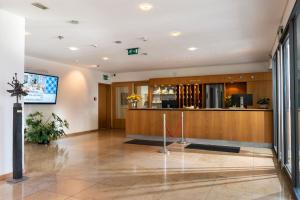 a lobby of a hospital with a reception counter at Hotel Aquino Berlin in Berlin