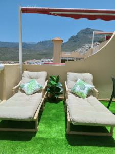 two beds on a balcony with green grass at Atlantic View in Adeje
