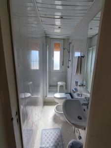 a white bathroom with two toilets and a sink at Hotel Primavera sul mare in Lido di Savio