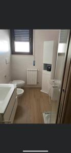 a bathroom with a sink and a toilet and a window at La dolce vita in Scanzano