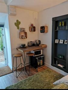 a kitchen with a table and stools in a room at The Coo Shed in Balfron