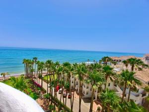a view of the beach from the balcony of a resort at Algaida, beach apartment in Mijas Costa