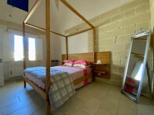 a bedroom with a canopy bed and a mirror at CH Guest House in Vernole +57 photos