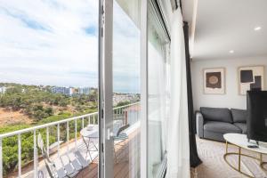 a living room with a balcony with a couch at Ocean Apartment by Olala Homes in Cascais