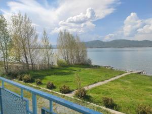 a view from the balcony of a lake with a blue fence at Sevan - White House in Sevan